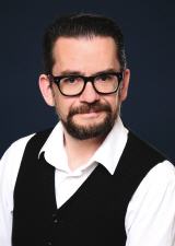 Portrait Achim Happel mit Bart und Brille